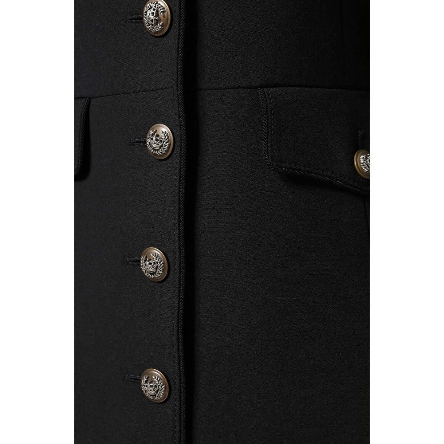 Close-up of Dolce & Gabbana black wool single breasted trench coat with button details and logo accents, showcasing luxury craftsmanship.