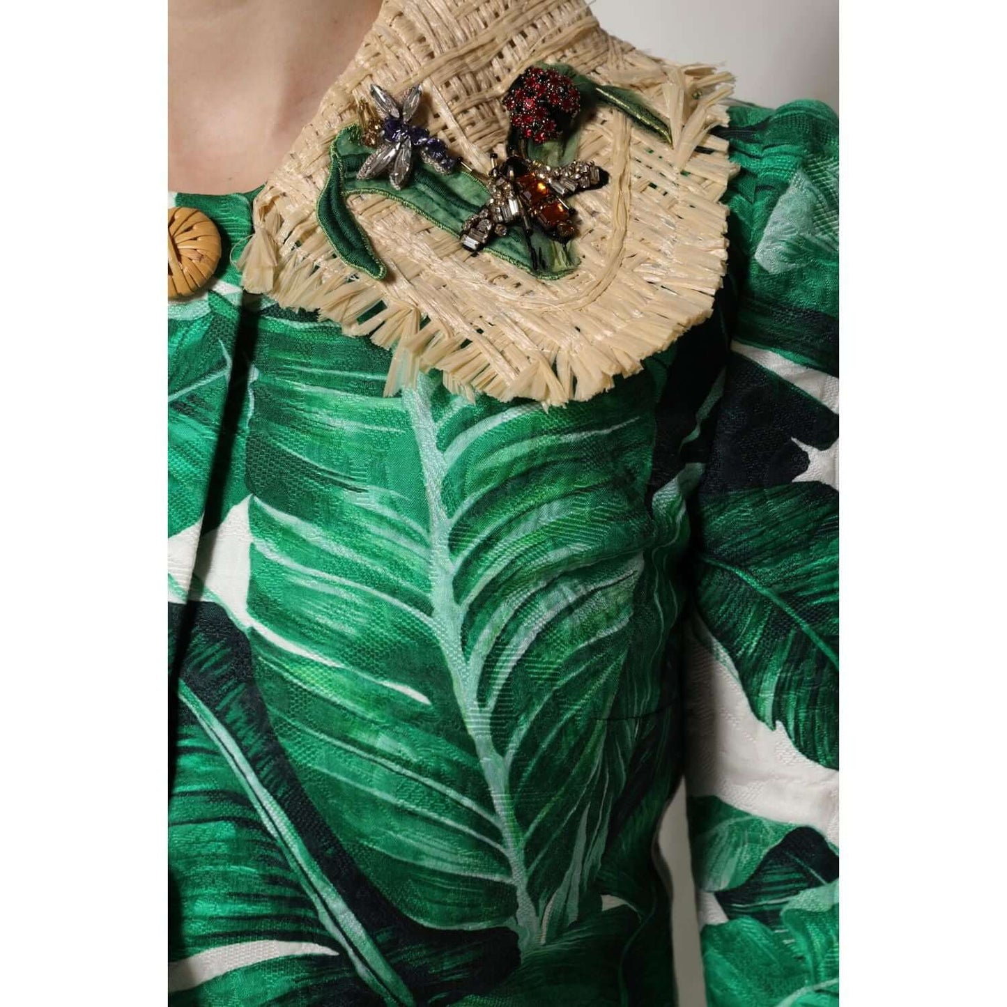 Dolce & Gabbana multicolor leaf print trenchcoat with embellished collar, close-up view of intricate details, luxury fashion.