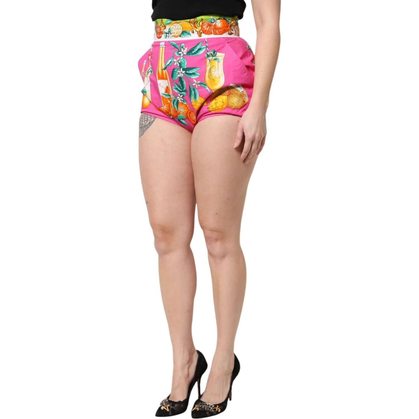 Dolce & Gabbana pink high waist hot pants with fruit print, model wearing heels, luxury Italian fashion shorts.