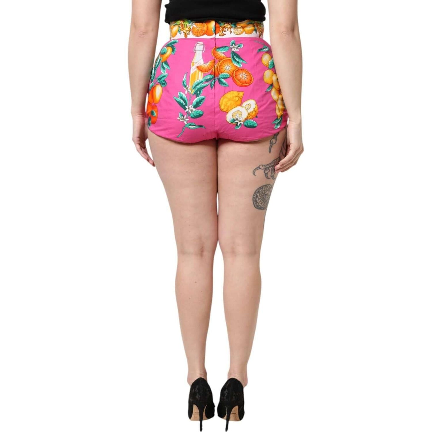 Back view of Dolce & Gabbana pink high waist hot pants with vibrant fruit print, showcasing zipper closure and logo details.