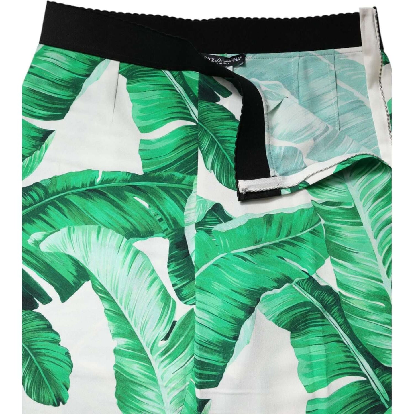 High waist Dolce & Gabbana pants with green leaf print, 100% viscose, zipper closure, made in Italy, showcasing luxury craftsmanship.