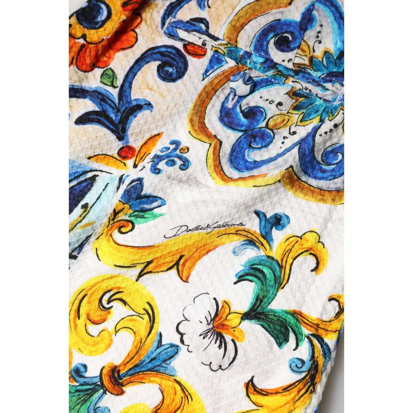 Dolce & Gabbana majolica print fabric detail on multicolor high waist shorts, showcasing intricate patchwork design.