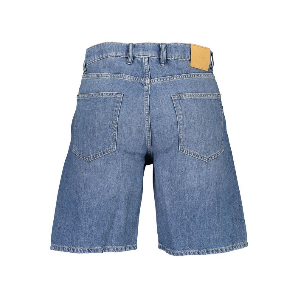 Back view of Gant blue cotton men's Bermuda jeans with chic faded effect, showcasing iconic logo and superior craftsmanship.
