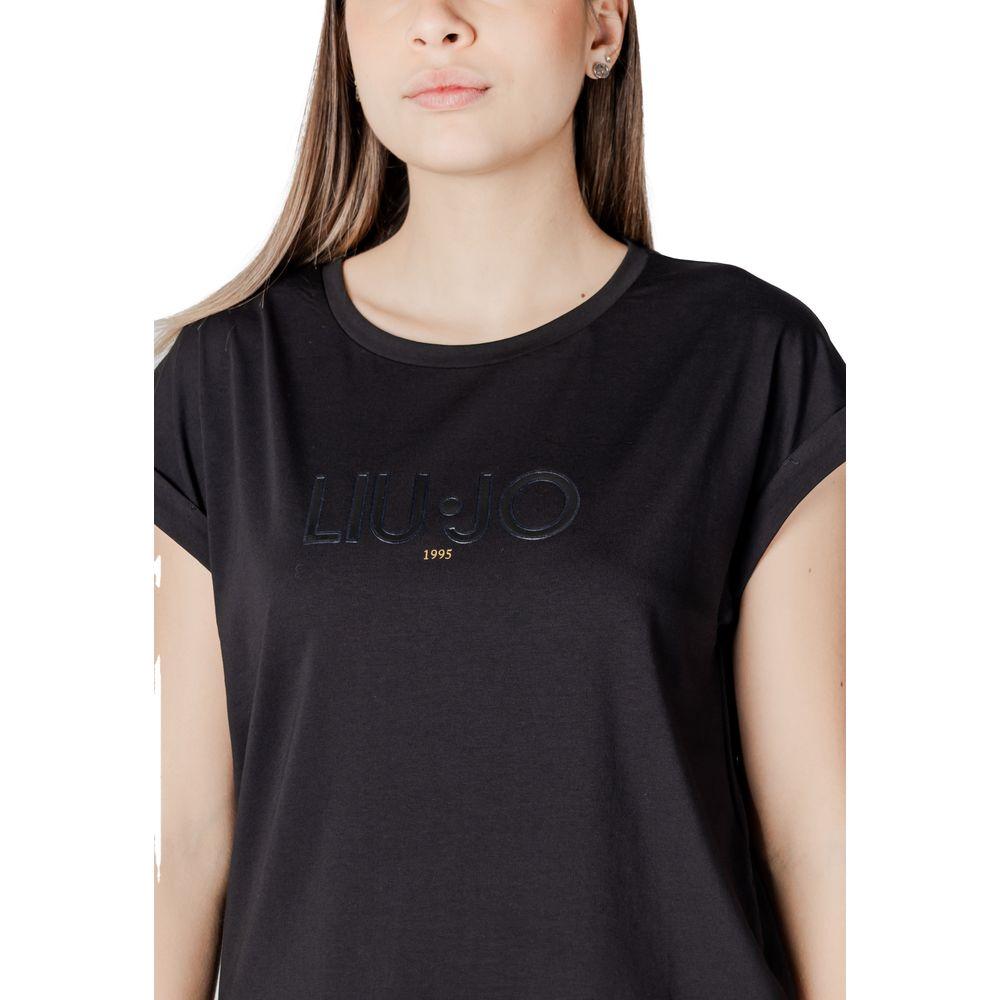 Woman wearing Liu Jo black cotton t-shirt, short sleeves, featuring a simple yet elegant design, ideal for versatile casual or elegant outfits.
