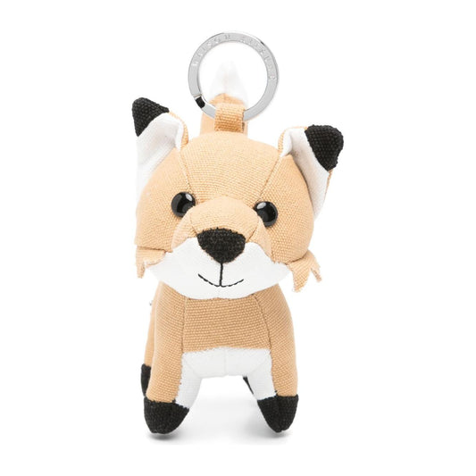 Beige Maison Kitsuné fox motif keyring charm with pop-up animal ears and engraved logo, perfect for accessorizing bags.