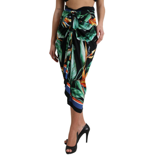 Woman wearing Dolce & Gabbana Black Strelitzia High Waist Wrap Midi Skirt with floral pattern and high heels.