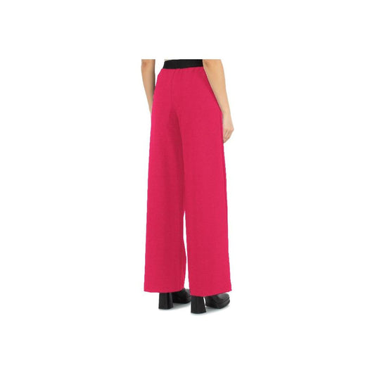 Fuchsia Comme des Fuckdown satin pants with logoed elastic waistband, side view showcasing fit and pockets.