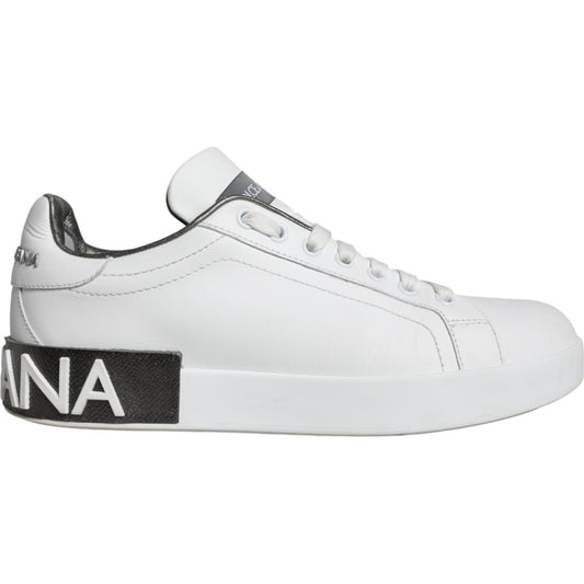 Dolce & Gabbana white leather Portofino low top sneaker with black sole, side logo detail, and lace-up closure.