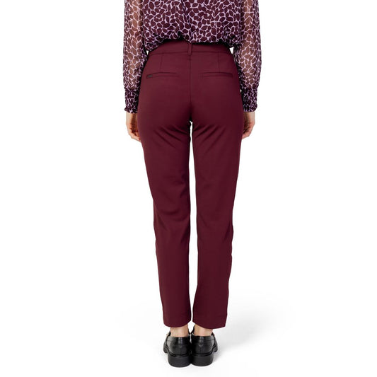 Woman wearing Street One Bordeaux polyester cigarette pants, fall/winter collection, rear view, formal attire with black shoes.