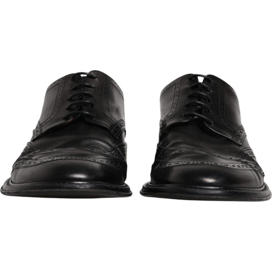 Dolce & Gabbana black leather derby wingtip formal shoes with lace-up closure, crafted from 100% calfskin leather, front view.