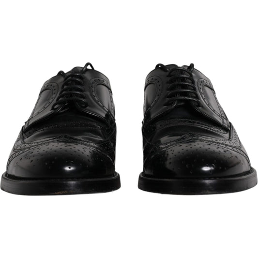 Dolce & Gabbana black leather derby wingtip formal shoes, made from calfskin leather, featuring lace-up closure and logo details.
