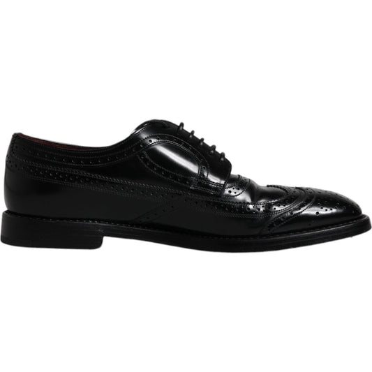 Dolce & Gabbana black leather derby wingtip formal shoes made from calfskin with lace-up closure and logo details, side view.