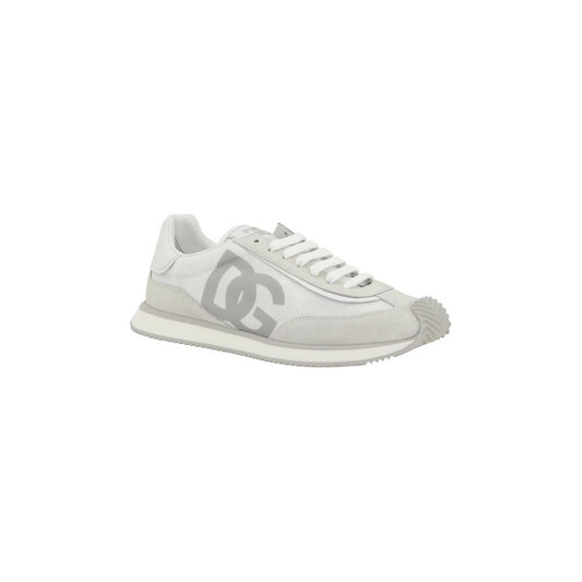 Dolce & Gabbana sneakers with suede details, extended toe, and monogram on heel, featuring lace-up closure and textured sole.