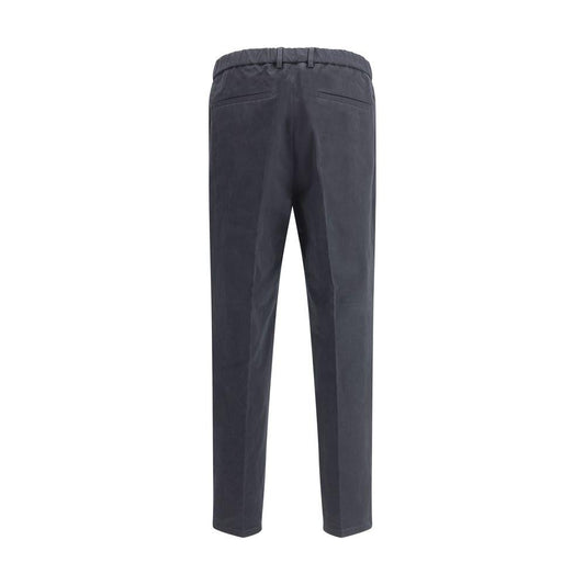 Back view of Jil Sander cropped pants featuring welt pockets, elasticized waistband, and minimalist design in dark color.