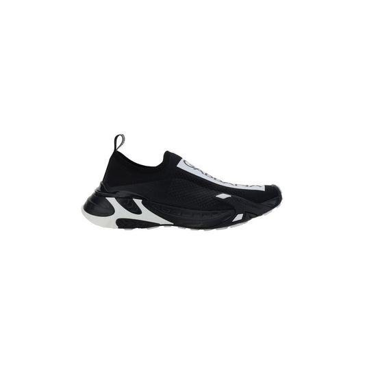 Dolce & Gabbana slip-on sneakers with round toe, textured panelled sole, and contrasting logo label on front in black and white.