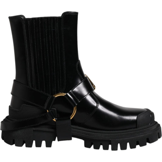 Dolce & Gabbana black leather mid-calf slip-on trekking boots with gold detailing and rubber sole, minor scratch on right shoe.