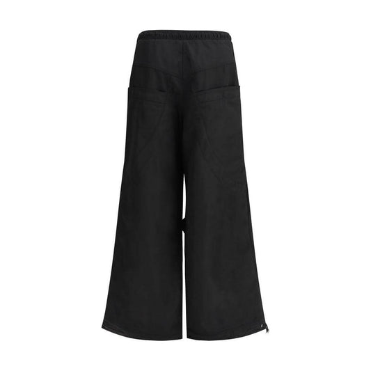 The Attico black nylon cargo pants with wide legs and back patch pockets, showcasing urban style and functionality.