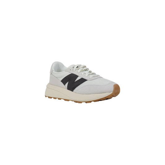 New Balance white suede leather sneaker with mesh detailing, rubber outsole, and sleek design for style and comfort.