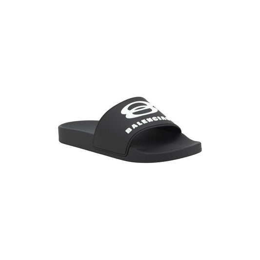 Black Balenciaga Logo Slippers with embossed logo on band, featuring a round toe and flat sole for stylish comfort.