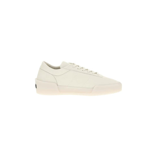 Fear Of God Aerobic Low Sneakers in white leather with elongated toe and rubber sole, featuring lace-up closure and monogram patch on heel.