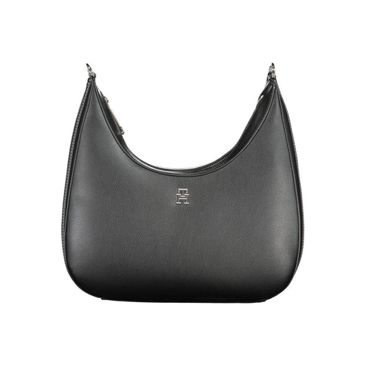 Tommy Hilfiger black polyester handbag with adjustable strap, zip closure, and logo detail. Features internal pocket and contrasting accents.