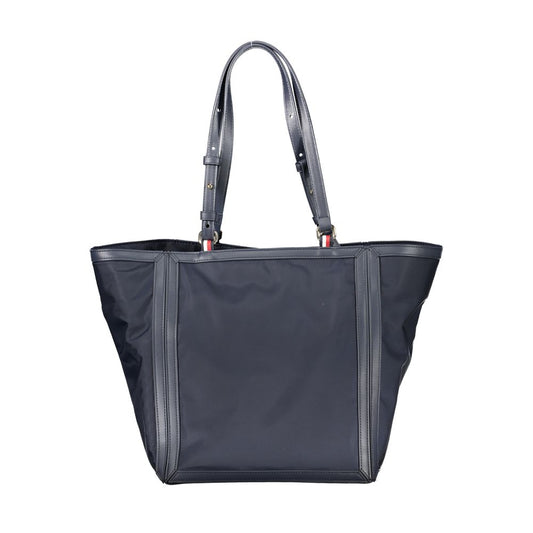 Tommy Hilfiger blue polyester handbag with adjustable shoulder handles, zip closure, and logo detailing, made from recycled materials.