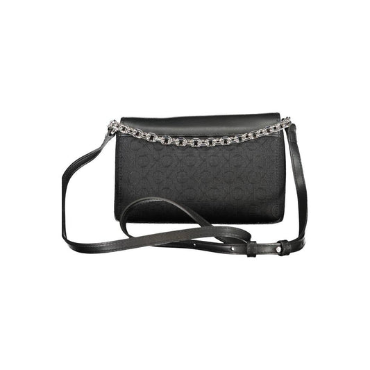 Calvin Klein black polyester handbag with chain handle, adjustable shoulder strap, two compartments, contrast details, and swivel closure.