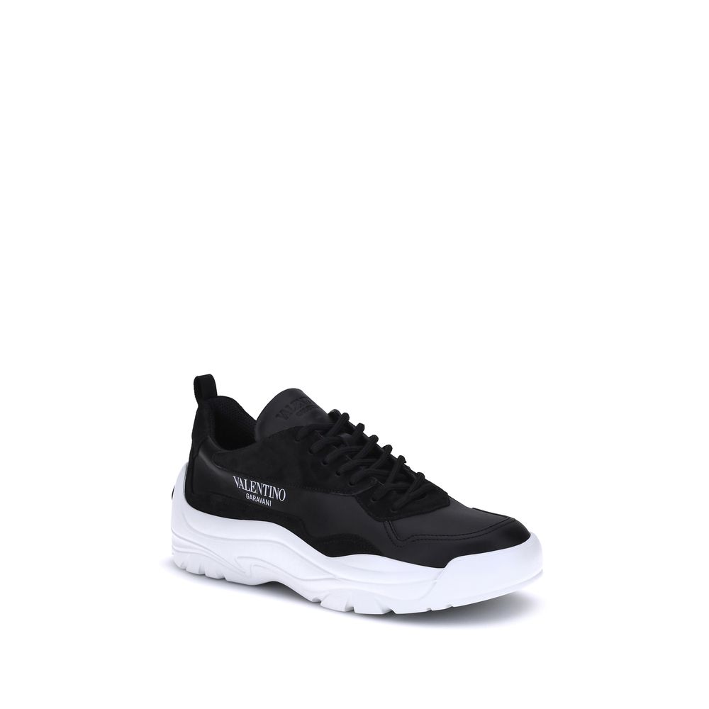 Valentino Garavani Black Calf Leather Bos Taurus Chunky Sneakers featuring embossed logo, lace-up closure, and smooth suede detail.