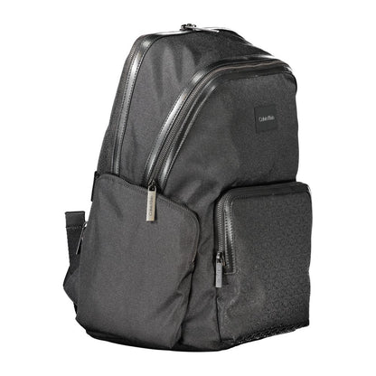 Calvin Klein Black Polyester Backpack with multiple pockets and contrasting details, featuring logo and adjustable straps.