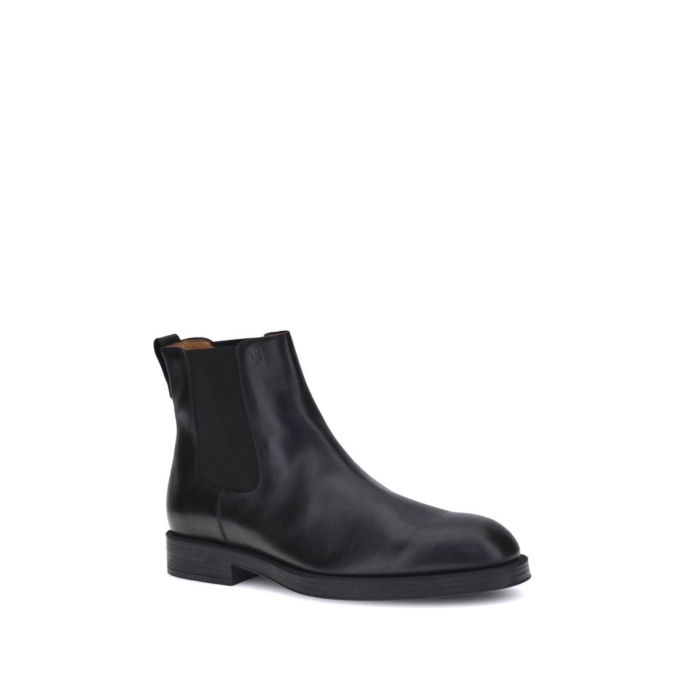 Tod's Black Calf Leather Bos Taurus Chelsea Boots with round toe and elastic side inserts, offering style and comfort for everyday wear.