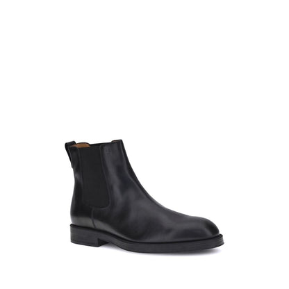 Tod's Black Calf Leather Bos Taurus Chelsea Boots with round toe and elastic side inserts, offering style and comfort for everyday wear.