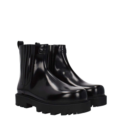 Givenchy Black Leather Ankle Boots with rubber sole and mid heels, featuring front and back logo, round toe design.