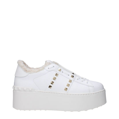 Valentino Garavani White Leather Platform Sneakers with studs, fur lining, and rubber wedge sole, round toe, lace-up closure.
