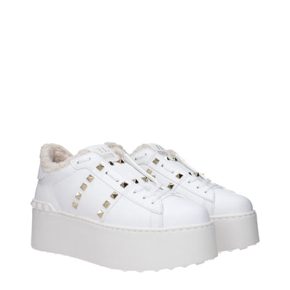 Valentino Garavani White Leather Platform Sneakers with studs, lace-up closure, fur lining, and rubber sole.