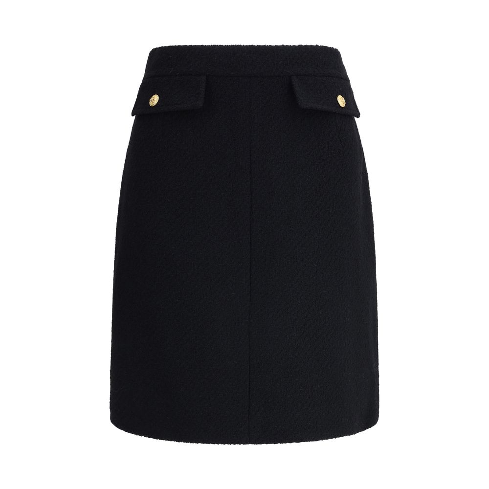 Chloé Black Wool Midi Skirt with gold-tone button flap pockets, crafted from premium bouclé wool for a sleek, structured silhouette.