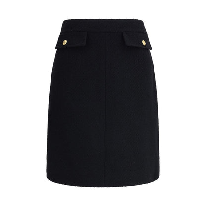 Chloé Black Wool Midi Skirt with gold-tone button flap pockets, crafted from premium bouclé wool for a sleek, structured silhouette.