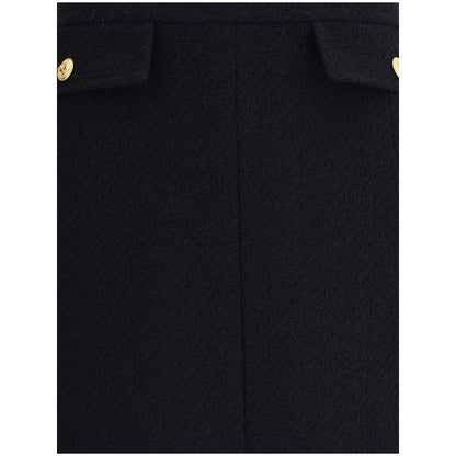 Chloé Black Wool Midi Skirt featuring gold-tone button flap pockets and a sleek bouclé finish, designed for a sophisticated look.