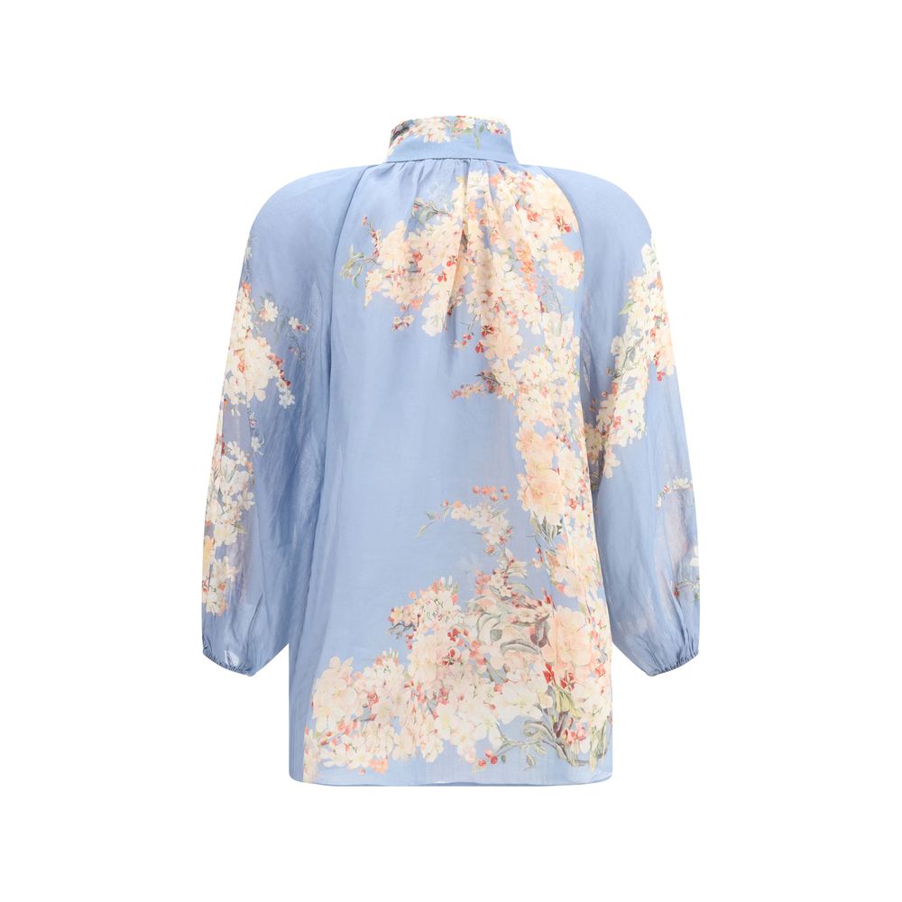 Zimmermann Light Blue Ramie Blouse with floral print, featuring puff sleeves and lace detailing for a romantic and delicate look.