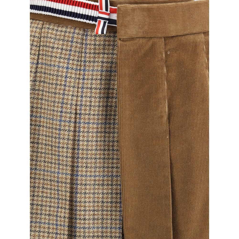 Close-up of Thom Browne Brown Wool Mini Skirt with houndstooth pattern, velvet texture, and striped side band, showcasing stylish detail.