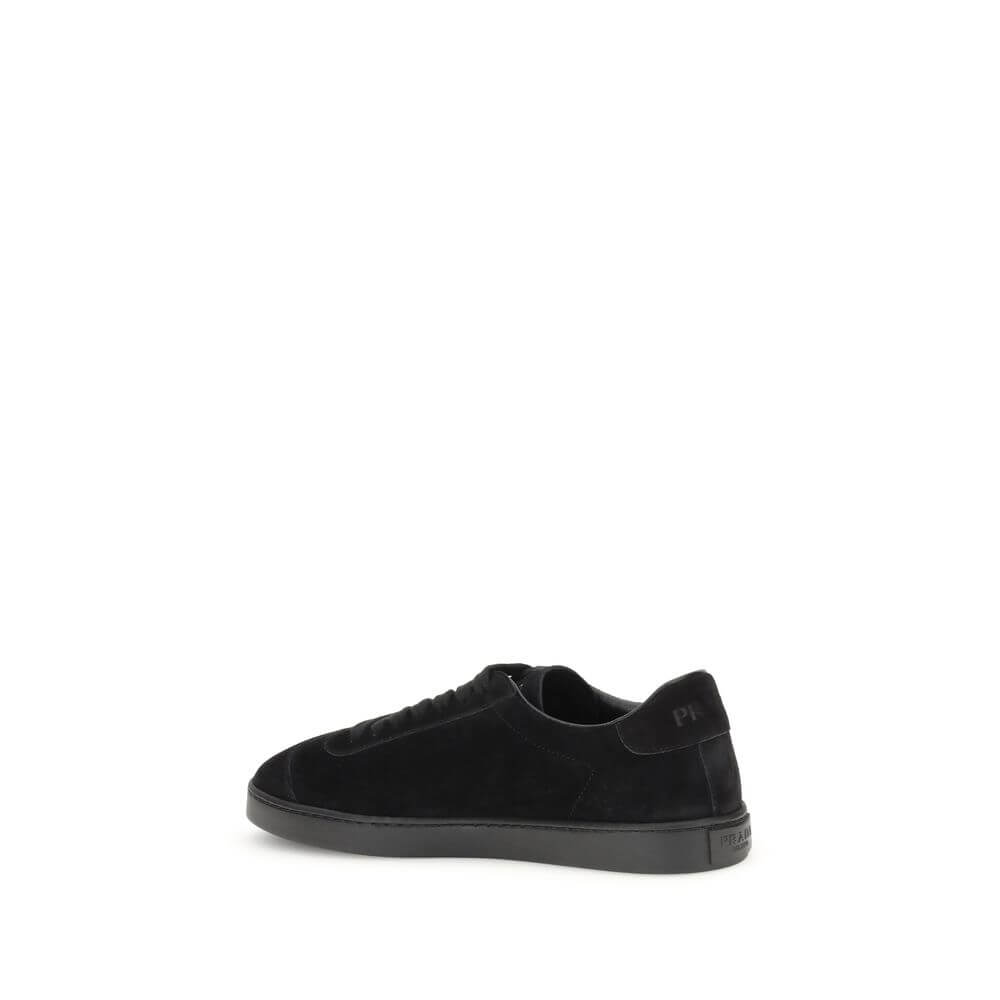 Prada Black Calf Leather Bos Taurus Low Top Sneakers with rubber sole, featuring iconic triangular plaque and tone-on-tone logo.