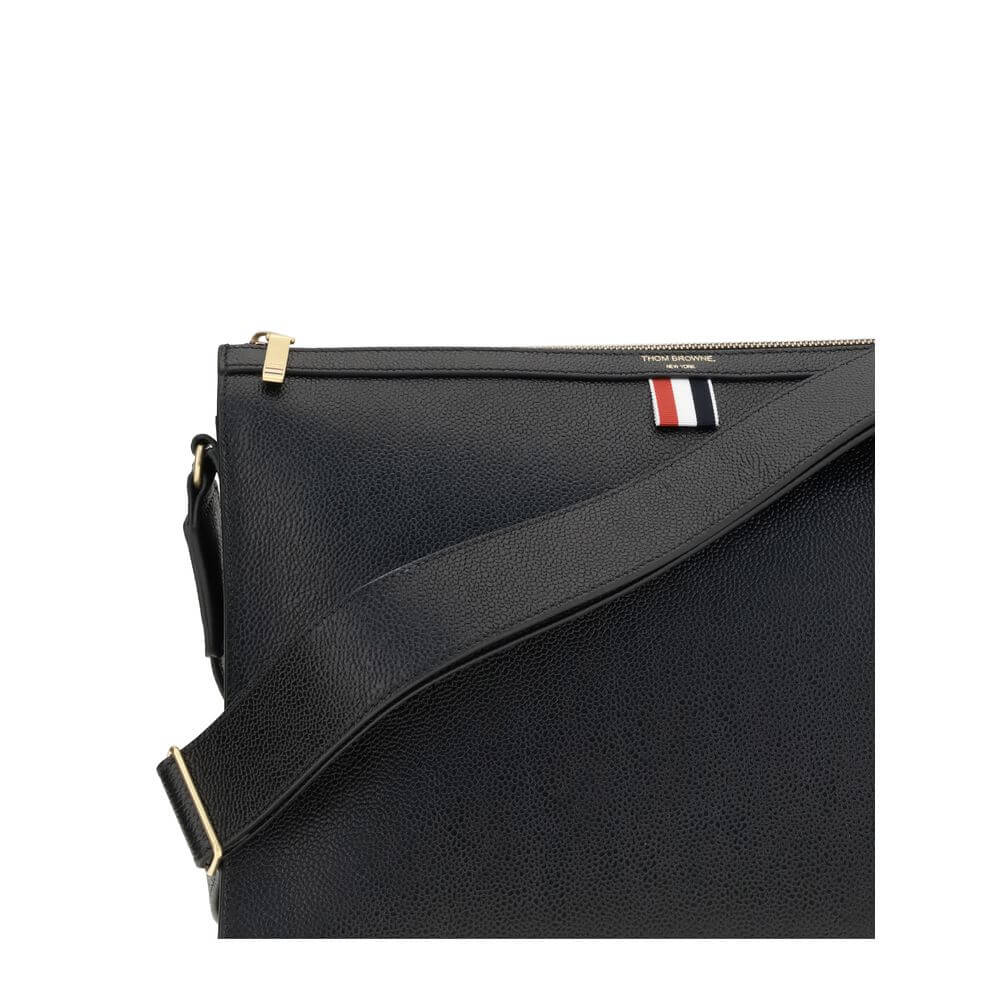 Thom Browne Black Calf Leather Bos Taurus Clutch Bag with zipper closure and tricolor detail, featuring an adjustable shoulder strap.