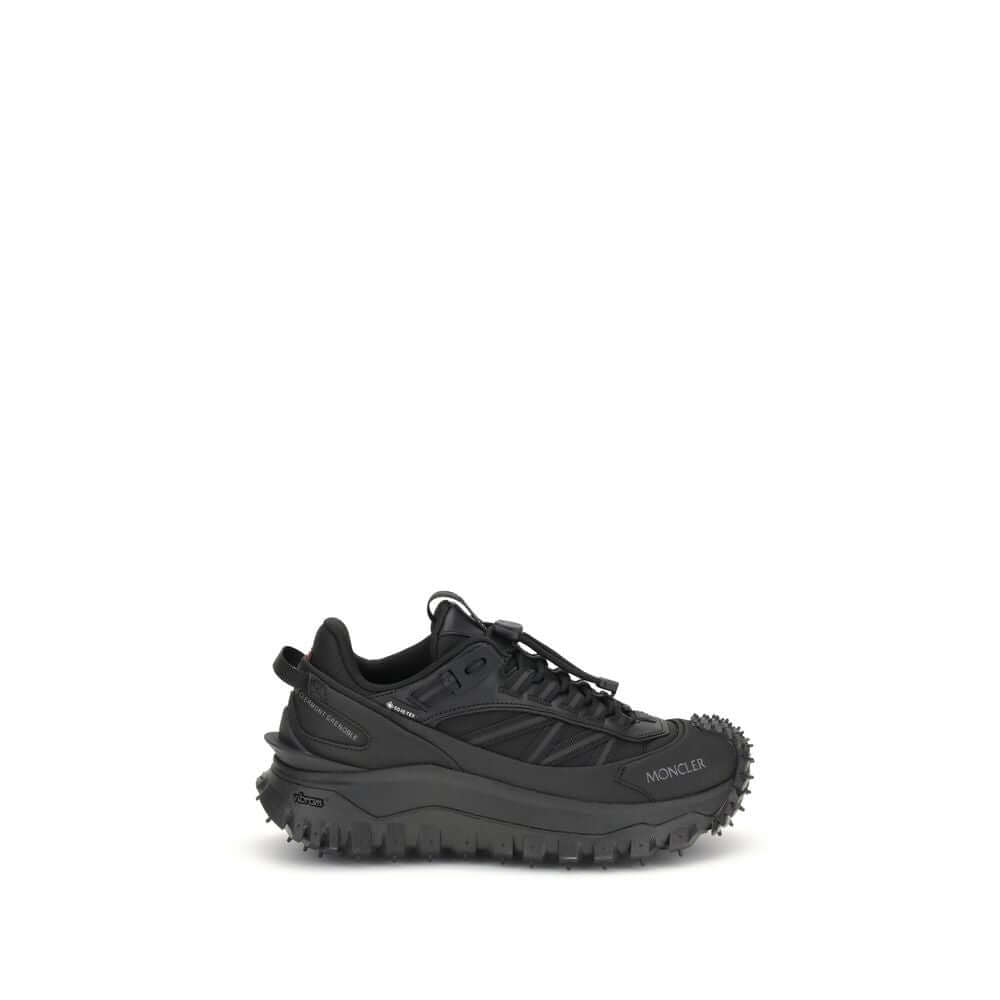 Moncler Black Calf Leather Bos Taurus Athletic Sneakers with reflective inserts and logo accents on black trail shoes.