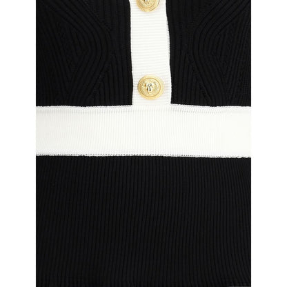 Close-up of Balmain Black Viscose Casual Dress with ribbed knit texture and embossed gold buttons on front closure.