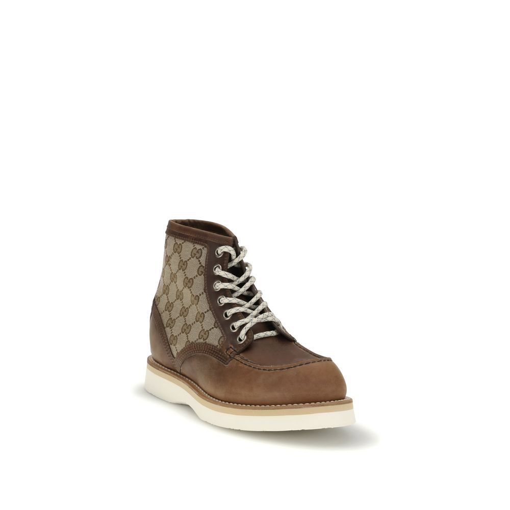 Gucci Brown Leather Lace-Up Boots with GG fabric insert and Goodyear construction on white background.