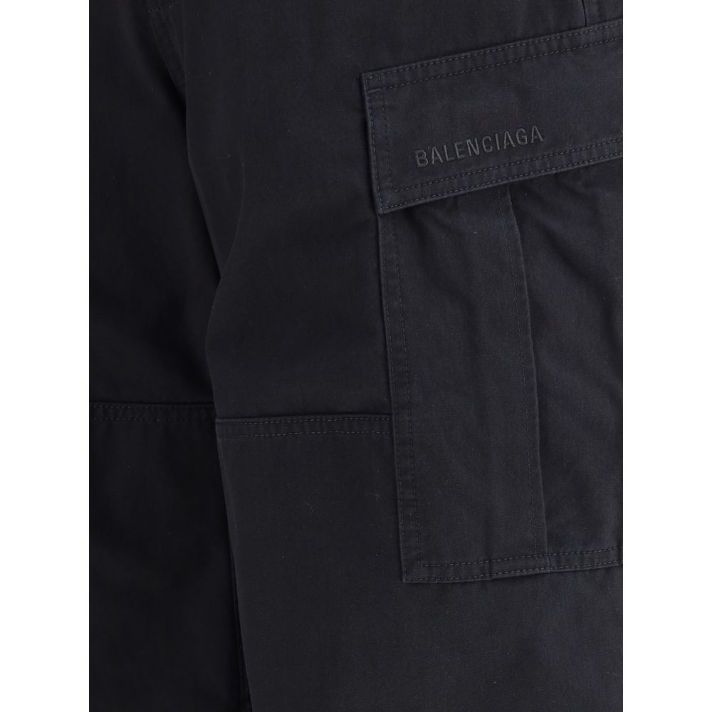 Balenciaga Black Cotton Cargo Pants with pockets and signature detailing on black denim, showcasing urban design aesthetics.