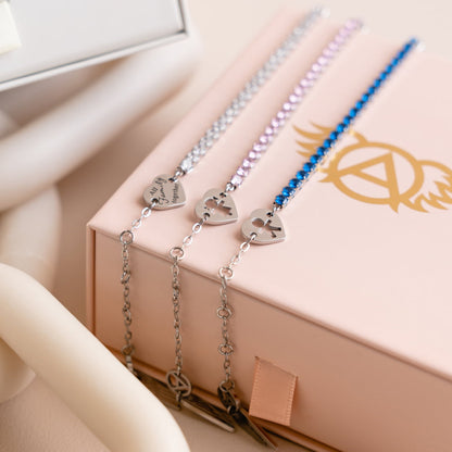 Elegant AN JEWELS JEWELRY Mod. AL.BLIYMBL bracelets in silver, pink, and blue displayed on a branded box against a soft background.