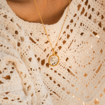 Close-up of AN JEWELS JEWELRY Mod. AL.NSOKSSYC necklace with a heart-shaped pendant, worn on a white lace top.