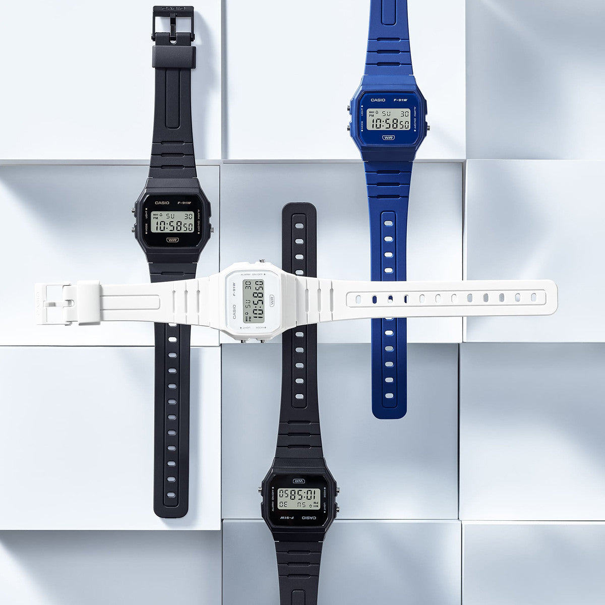CASIO VINTAGE Mod. F-91 BIO RESIN STRAP - BLUE wristwatches with multifunction quartz movement in black, white, and blue designs.