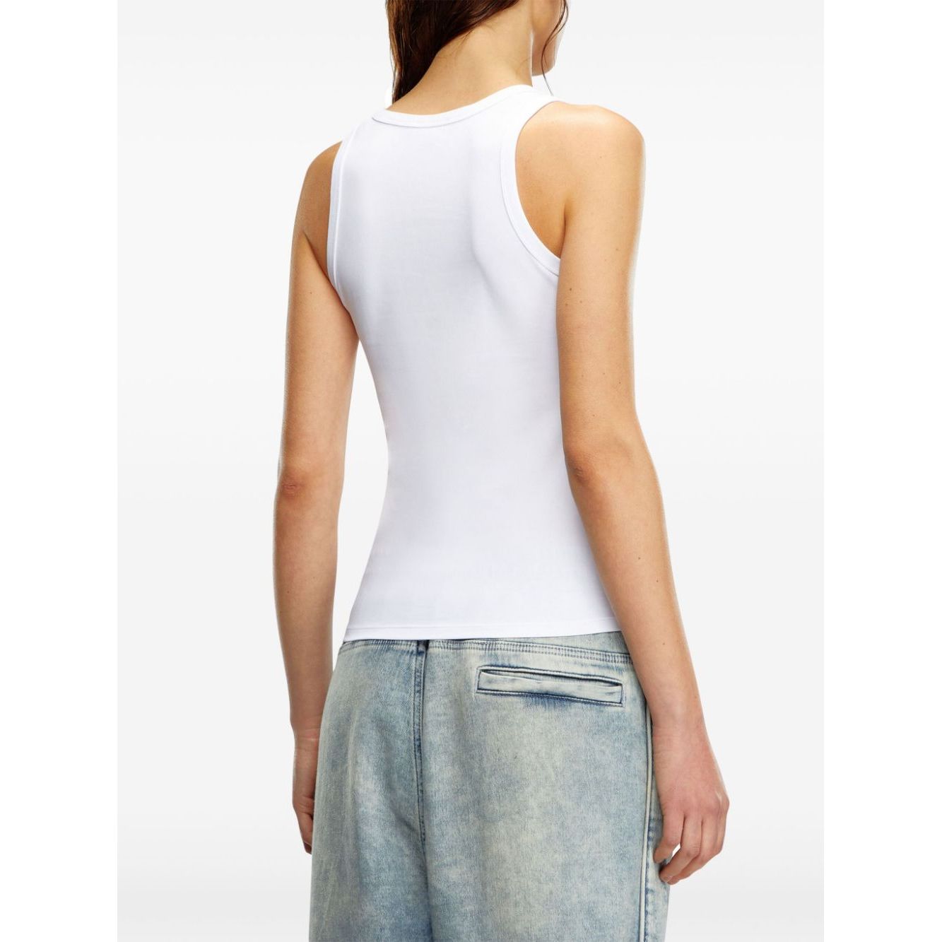 Back view of Diesel Top White sleeveless cotton jersey with crew neck and straight hem, worn with denim jeans.