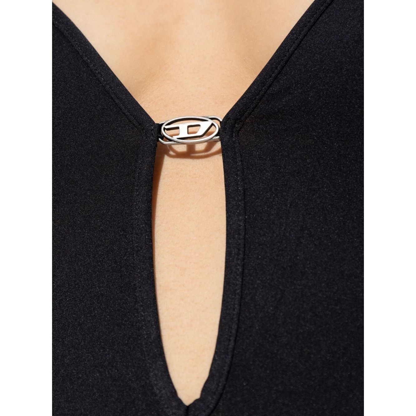 Close-up of Diesel Underwear Black bodysuit with oval-D detail, adjustable spaghetti straps, and low back.